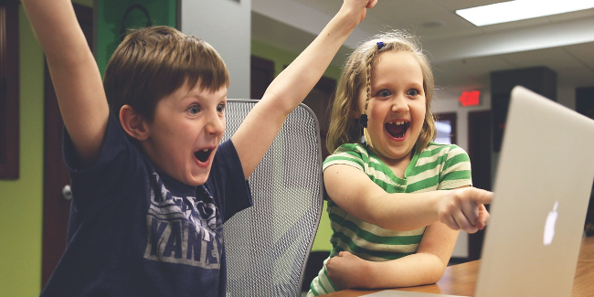 Children playing with a laptop