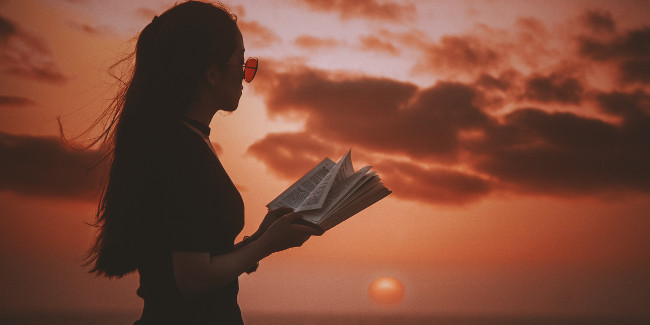 woman reading at sunset
